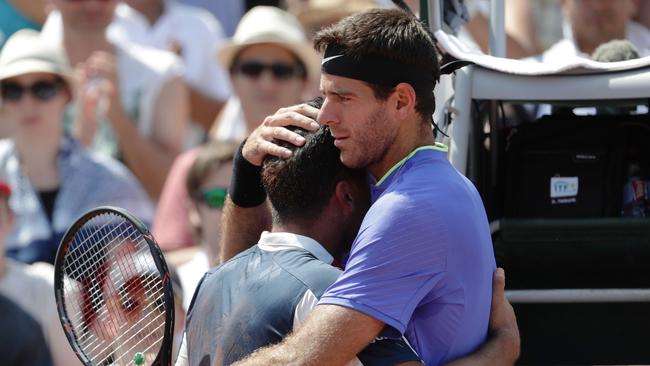 Spain's Nicolas Almagro is comforted by Argentina's Juan Martin Del Potro.