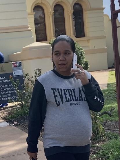 Drug runner Deanna Morris takes a call as she leaves Dubbo Local Court. Picture: Ryan Young