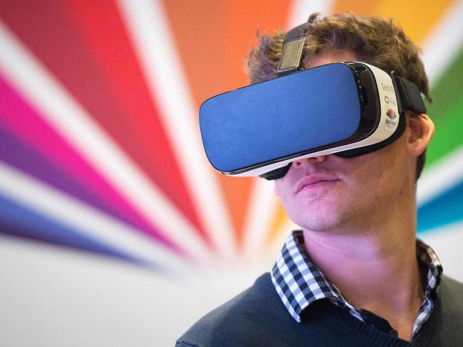 A man tries Virtual Reality goggles at a stand of the AI Expo Africa on September 10, 2018, in Cape Town. This expo is the first of it's kind dealing with the Artificial Intelligence industry on the African continent. (Photo by RODGER BOSCH / AFP)