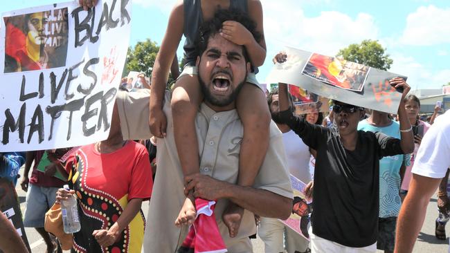 Algen Donahue leads a march through the streets of Mareeba after his twin brother was shot dead on Saturday. Picture: Peter Carruthers