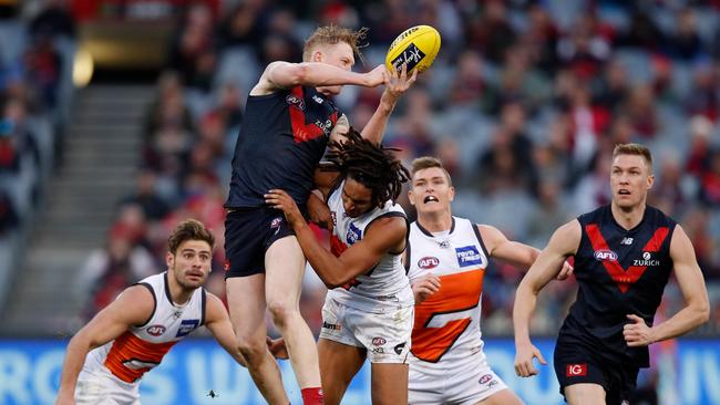 Clayton Oliver handballs over the top. Picture: Getty Images