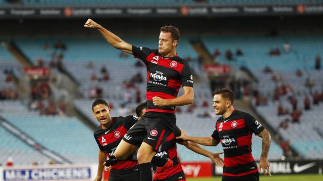 Oriol Riera (top) of the Wanderers celebrates