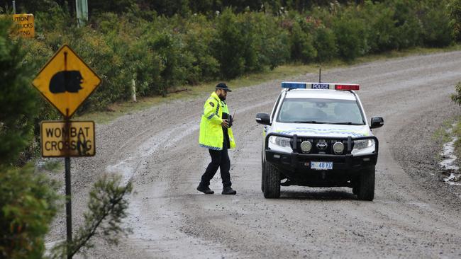 Tasmania Police at a roadblock at Henty Gold Mine in Tasmania's west where a man is believed to be missing following a rock fall. Picture: Grant Wells