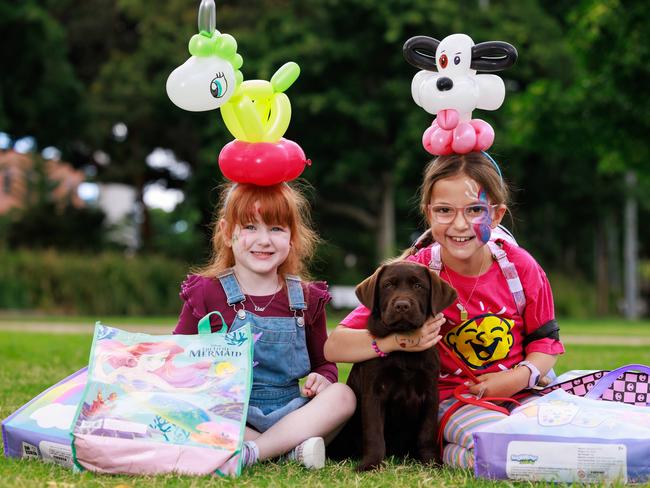 Daily Telegraph. 21, February, 2024.Elsie Donnelly, 4, Maisy, and Eve Daher, 8, at The Royal Agricultural Society of NSW Showbagt Launch, at Sydney Showground today. Picture: Justin Lloyd.