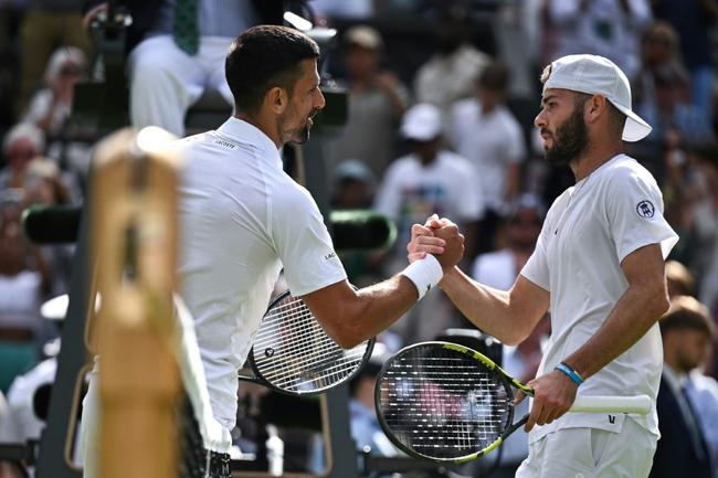 Novak Djokovic shakes hands with Jacob Fearnley at the end of their second-round match at Wimbledon