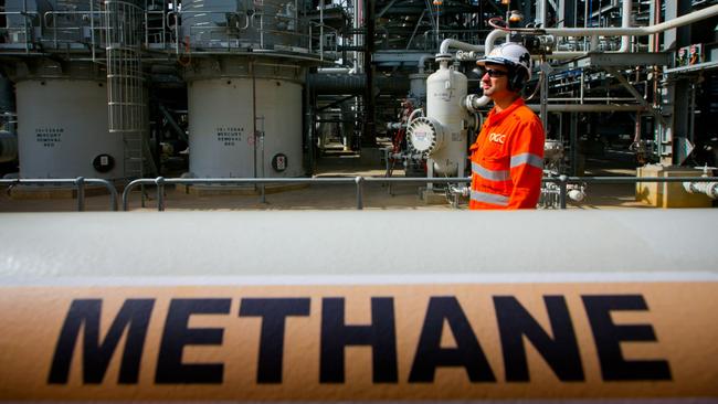 A worker walks past a gas pipe marked "Methane" at the Curtis Island liquefied natural gas (LNG) plant, a part of the Queensland Curtis Liquefied Natural Gas (QCLNG) project site operated by QGC Pty, a unit of Royal Dutch Shell Plc, in Gladstone, Australia, on Wednesday, June 15, 2016. Gas from more than 2,500 wells travels hundreds of miles by pipeline to the project, where it's chilled and pumped into 10-story-high tanks before being loaded onto massive ships. Photographer: Patrick Hamilton/Bloomberg