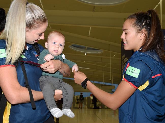 23/3/17 AFLW - crows women leave for Grand Final at Adelaide Airport. Deni Varnhagen with one of Erin Phillip's children. (NEED TO ID THE OTHER PLAYER, COULD BE JUSTINE MULES). Picture Roger Wyman