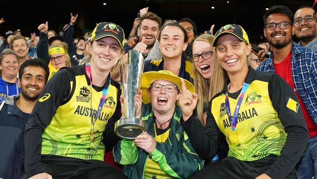 Rachael Haynes and Ashleigh Gardner of Australia celebrate with the Women’s T20 World Cup trophy. AAP Image/Scott Barbour