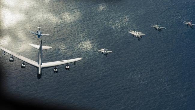 Japanese and US fighter jets fly in formation over the Northern Mariana Islands during a military exercise. Picture: LAC Kurt Lewis/Defence