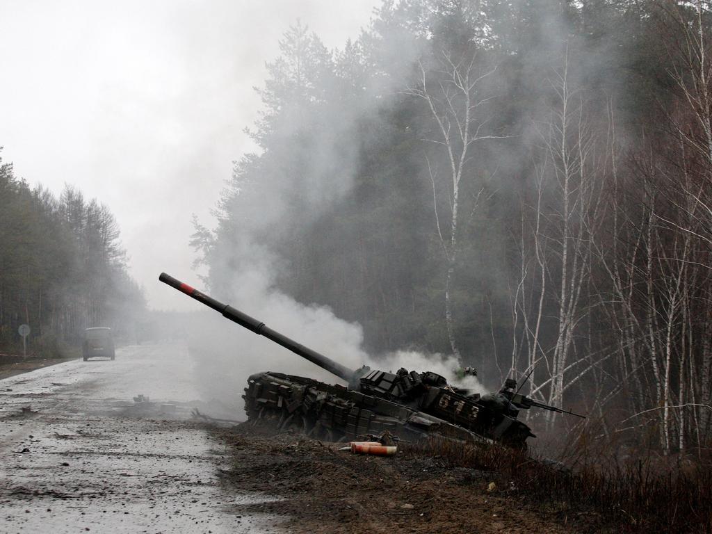 Smoke rises from a Russian tank destroyed by the Ukrainian forces on the side of a road in Lugansk region on February 26, 2022. Picture: Anatolii Stepanov / AFP