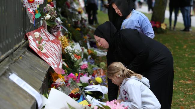 Hundreds of floral tributes run the length of a wall at the Botanic Gardens in Christchurch. Picture: Gary Ramage