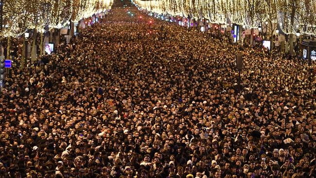 People party on the Champs-Elysee in Paris on Sunday. Picture: AFP