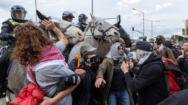 Protesters clash with police horses. Picture: Jake Nowakowski