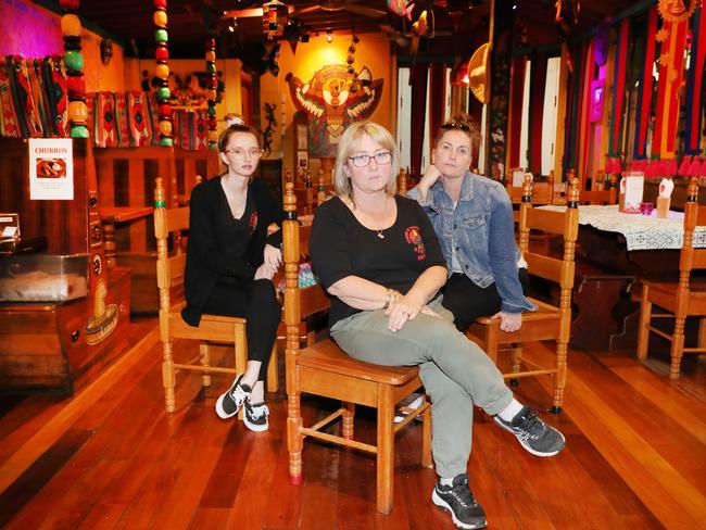 the Iconic Old Burleigh Theatre Arcade has been sold, and its fate depends on the success of a last-minute bid by Gold Coast City Council to preserve it. Montezumas owner Teresa Worthington reflects on 41 years of history at the arcade for the restaurant with daughter Carly Worthington (left) and sister Rachelle Kyte (right). Picture Glenn Hampson