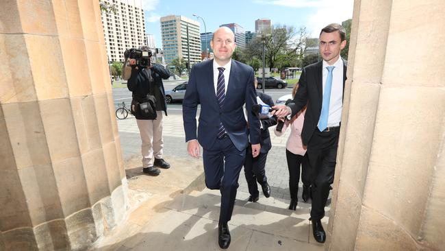 Sam Duluk, centre, arrives at the Adelaide Magistrates Court. Picture: Tait Schmaal.