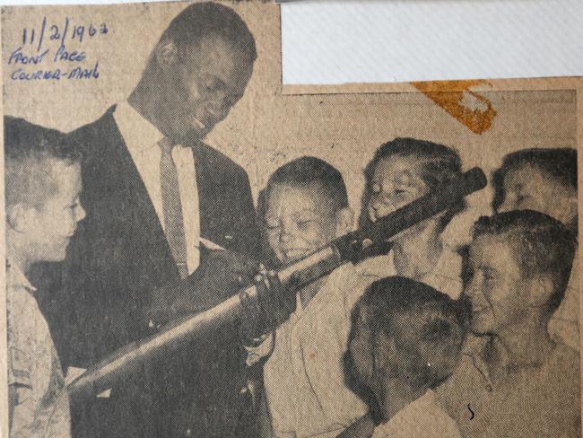 The front page picture from The Courier-Mail. Wes Hall signs 12-year John McCoy’s bat in 1962.