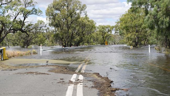 Floodwaters flow over Taylorville Road. Picture: The Advertiser/ Morgan Sette