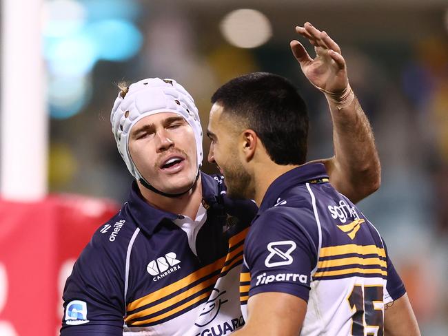Tom Wright celebrates a try with teammates during the Burnbies’ win against the Hurricanes. Picture: Getty Images