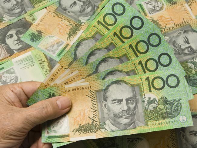 A Hand fanning out 500 Australian dollars. Australian money cash generic