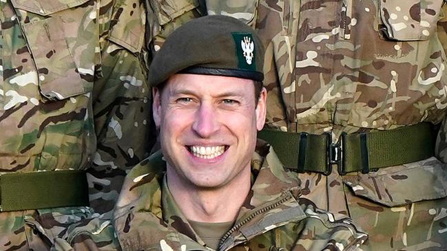 Britain's Prince William, Prince of Wales (C), in his role as Colonel-in-Chief, 1st Battalion Mercian Regiment, wears Army fatigues as he sits alongside alongside Lieutenant General Ian Cave (R) for a group photograph, during a visit to the regiment, near Salisbury, south west of England on November 23, 2023. (Photo by Andrew Matthews / POOL / AFP)