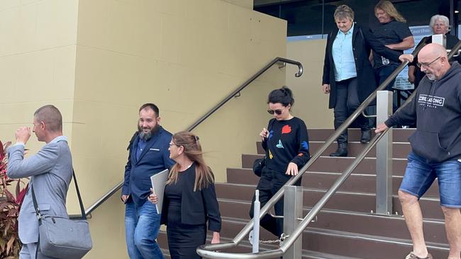 Watson (blue jacket, blue jeans, beard) leaves Mackay courthouse with a number of supports who had been in the gallery during his magistrates court hearing. Picture: Janessa Ekert