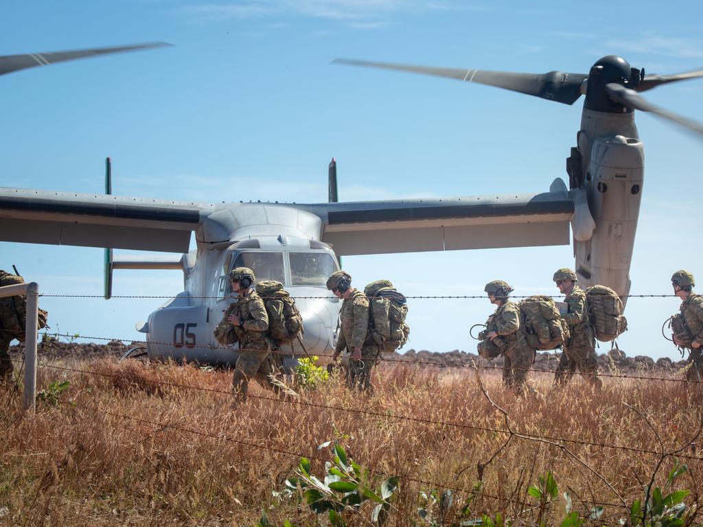 Australian Army soldiers carry their gear off a landing zone during an exercise in the Northern Territory.