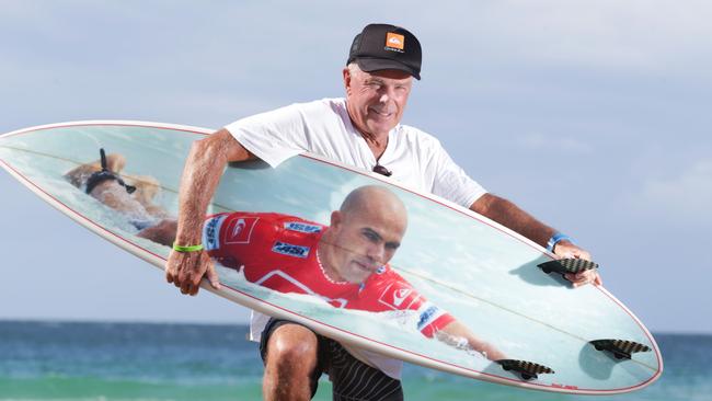 Gary Hill, 67, from Newcastle with his surfboard that has a picture of his surfing hero Kelly Slater on it. Gary is hoping for a signature from Kelly during the Quiksilver Pro. Pics Tim Marsden