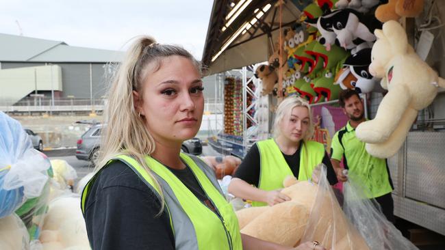 Savanah Fisher packing up the games in Sideshow Alley after the Ekka was cancelled due to COVID-19, Bowen Hills. Picture: Liam Kidston.