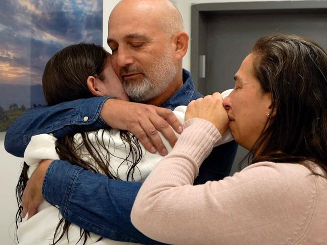 This handout picture released by the Israeli army shows former Israeli hostage Naama Levy reunited with family at an army screening point in Reim in southern Israel on January 25, 2025. Palestinian militants and Israel carried out a second hostage-prisoner swap on January 25 under the Gaza ceasefire deal, but a last-minute dispute blocked the expected return of hundreds of thousands of Palestinians to devastated northern Gaza. Four freed Israeli women hostages, all soldiers, arrived home in Israel after more than 15 months of captivity in the Palestinian territory. (Photo by Israeli Army / AFP) / === RESTRICTED TO EDITORIAL USE - MANDATORY CREDIT "AFP PHOTO / Handout / Israeli Army' - NO MARKETING NO ADVERTISING CAMPAIGNS - DISTRIBUTED AS A SERVICE TO CLIENTS ==