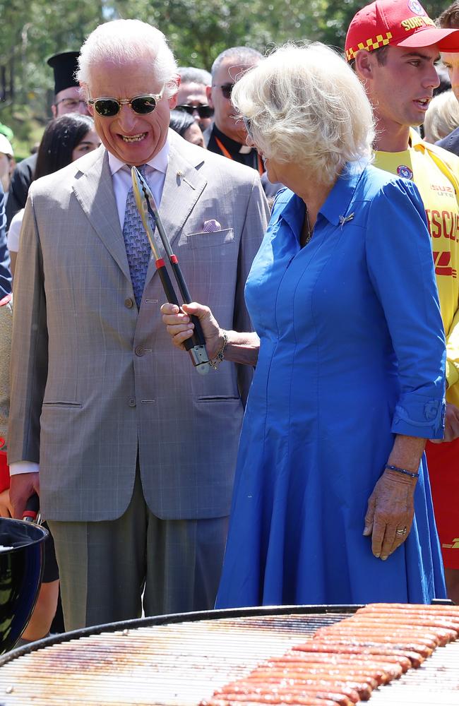 SYDNEY, AUSTRALIA - OCTOBER 22: King Charles III and Queen Camilla cook sausages for the food stalls at the Premier’s Community Barbeque at Parramatta Park on October 22, 2024 in Sydney, Australia. The King’s visit to Australia is his first as monarch, and the Commonwealth Heads of Government Meeting (CHOGM) in Samoa will be his first as head of the Commonwealth. (Photo by Chris Jackson/Getty Images)