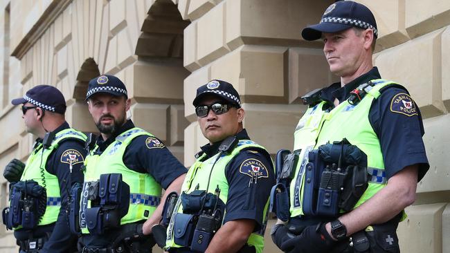 Tasmania Police members block the entrance to parliament. Protestors on the steps of the Tasmanian Parliament. Picture: Nikki Davis-Jones