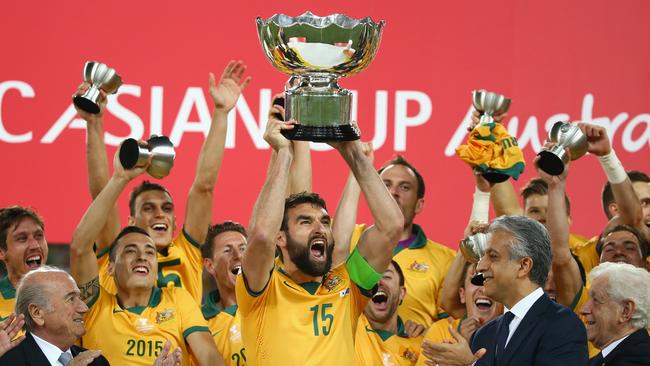 Mile Jedinak of Australia and his team celebrate as he lifts the Asian Cup trophy.