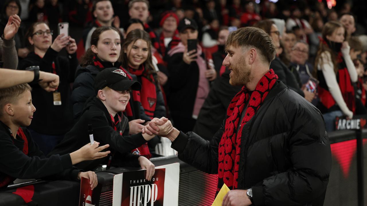 MELBOURNE, AUSTRALIA - AUGUST 16: Dyson Heppell of the Bombers greets fans during the round 23 AFL match between Essendon Bombers and Sydney Swans at Marvel Stadium, on August 16, 2024, in Melbourne, Australia. (Photo by Daniel Pockett/Getty Images)