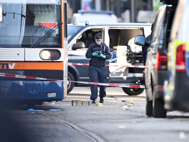 Police officers photograph the scene where two people were killed. Picture: Florian Wiegand / Getty