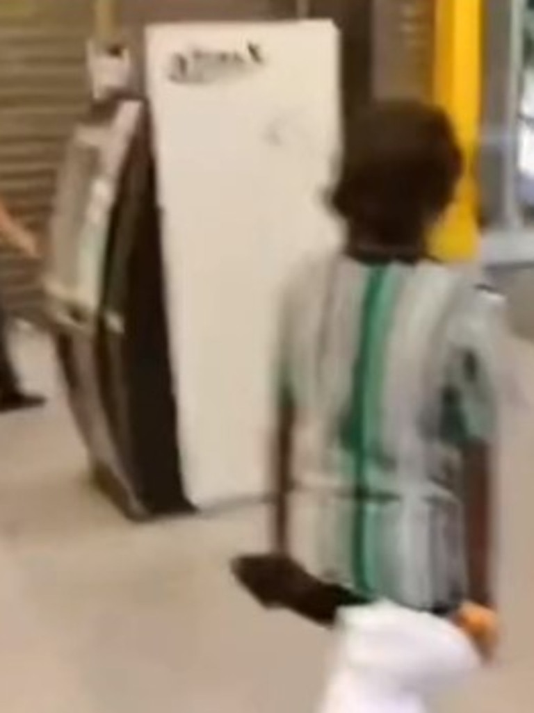 A young Aboriginal boy is filmed carrying a T-shirt out the front of a clothing store. Picture: TikTok