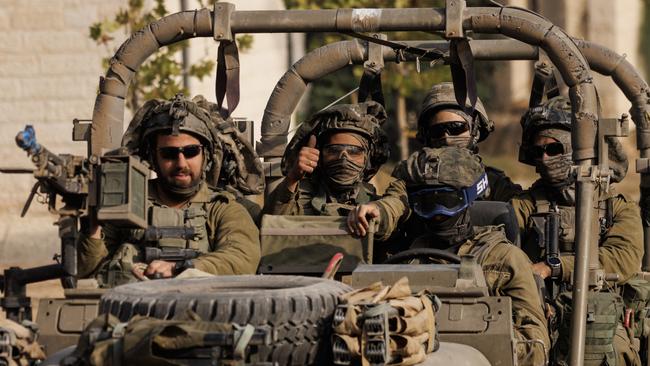 A soldier gives a thumbs-up as Israeli troops move towards Gaza. Picture: Getty Images