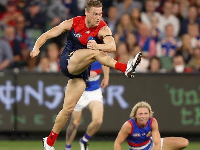 MELBOURNE, AUSTRALIA - MARCH 16: Tom McDonald of the Demons kicks the ball during the 2022 AFL Round 01 match between the Melbourne Demons and the Western Bulldogs at the Melbourne Cricket Ground on March 16, 2022 In Melbourne, Australia. (Photo by Michael Willson/AFL Photos via Getty Images)