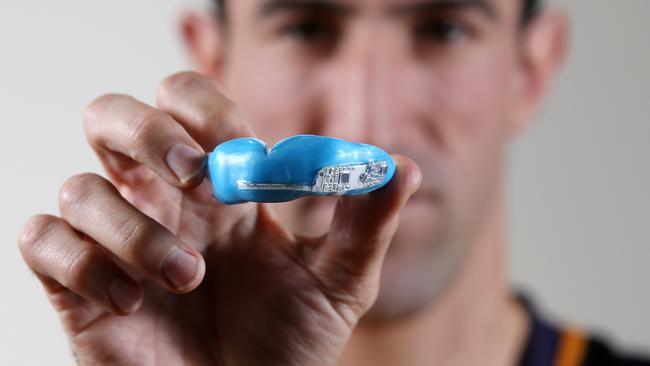 Mouthguard sports revolution. Ex north Melbourne defender Michael Firrito with the new microchipped mouthguard developed in Australia touted to be the future of concussion detection  . Pic: Michael Klein