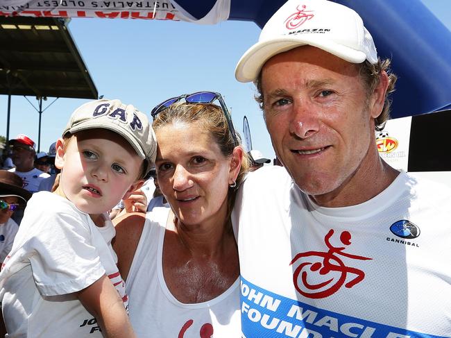 Wheelchair athlete John Maclean finishes competing in the Nepean Triathlon as an able-bodied athlete with his wife Amanda and son Jack at Penrith, Sydney. Pic Brett Costello