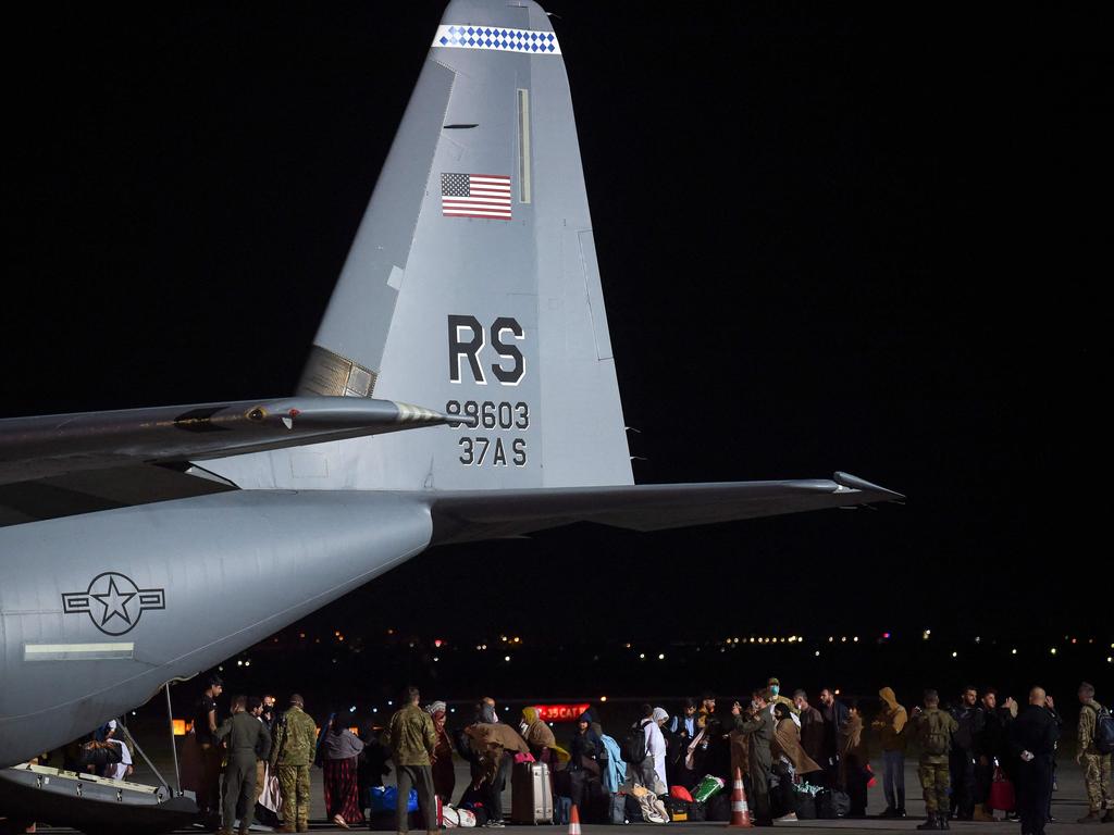 Afghan refugees, fleeing the Afghan capital Kabul, exit an US air force plane upon their arrival in Kosovo, which is temporarily taking thousands of Afghan refugees evacuated by US forces. Picture: AFP