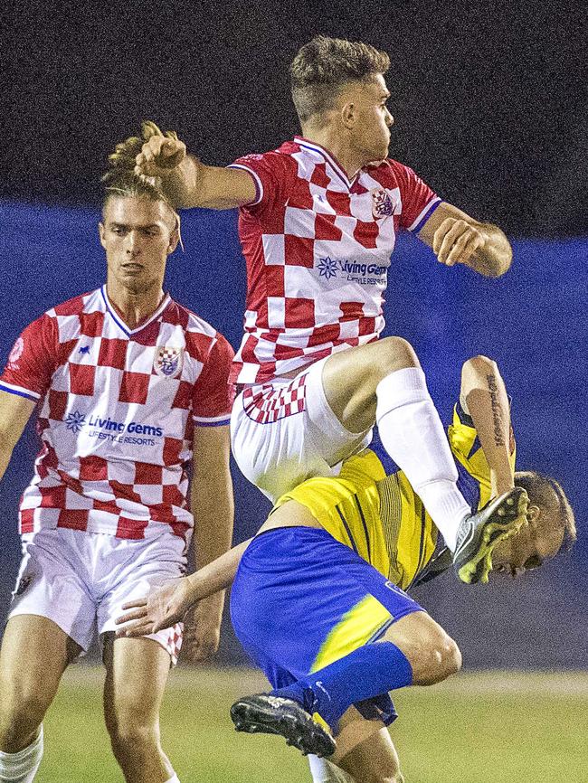 Broadbeach two-goal hero Shaun Robinson under pressure from Dean Wernerson of the Knights (red and white). Photo: Jerad Williams