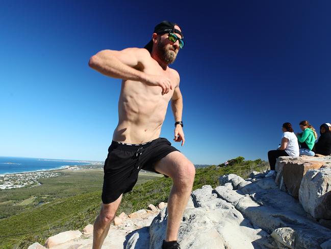 Mount Coolum local Scott Fisher 35, enjoys his first run on the peak of the mountain after Covid-19 restrictions on National Parks were lifted on Saturday. Scott would normally. Run up the mountain. 4-5 times a week and is looking forward to a return to his normal exercise routine. Photo Lachie Millard