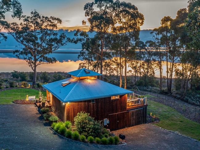 A drone shot of the Huon River Hideaway at golden hour shows just how close the property is to the peaceful, tranquil river. Picture: Jon Jarvela Photographs