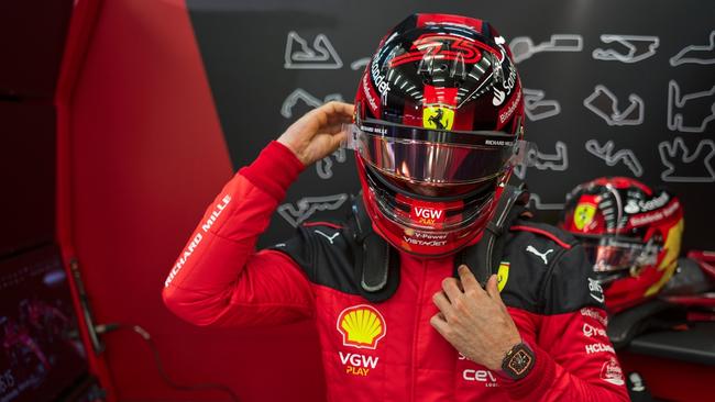 Ferrari driver Carlos Sainz suits up for a race.