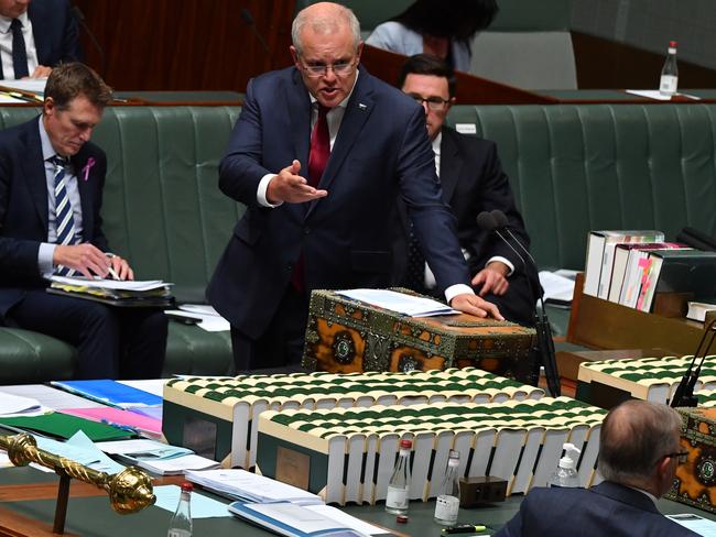 CANBERRA, AUSTRALIA - FEBRUARY 25: Prime Minister Scott Morrison (above) reacts to Leader of the Opposition Anthony Albanese during Question Time in the House of Representatives at Parliament House on February 25, 2021 in Canberra, Australia. Prime Minister Scott Morrison has lost a working majority in parliament after the Member for Hughes Craig KellyÃ¢â¬â¢s resigned yesterday and moved to the crossbench, warning he is prepared to vote against the government. Mr KellyÃ¢â¬â¢s decision to quit the Liberal Party came after the Prime Minister demanded he stop spreading misinformation about COVID-19 and take action against his office manager, Frank Zumbo, who faces allegations of inappropriate behaviour. (Photo by Sam Mooy/Getty Images)