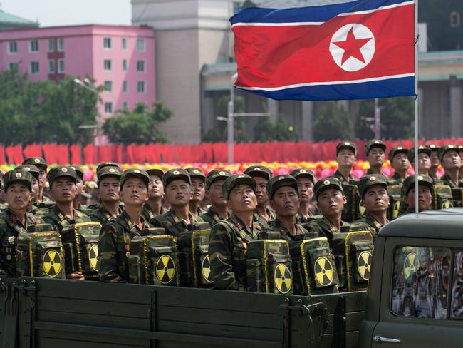 Korean People's Army (KPA) soldiers carrying packs marked with a radioactive symbol take part in a military parade in Pyongyang. Picture: AFP