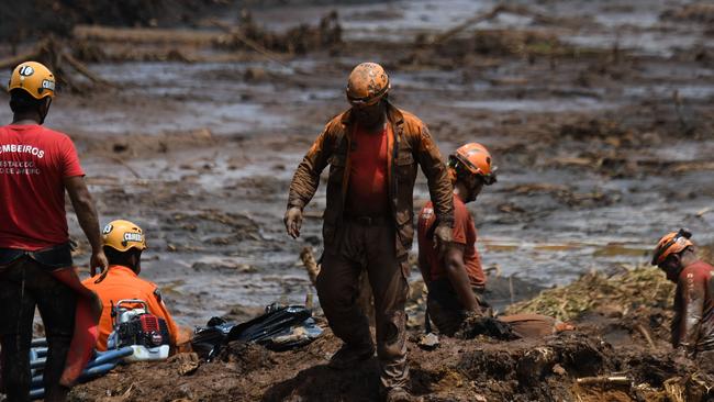 Rescuers search for victims after the dam collapse. Picture: AFP