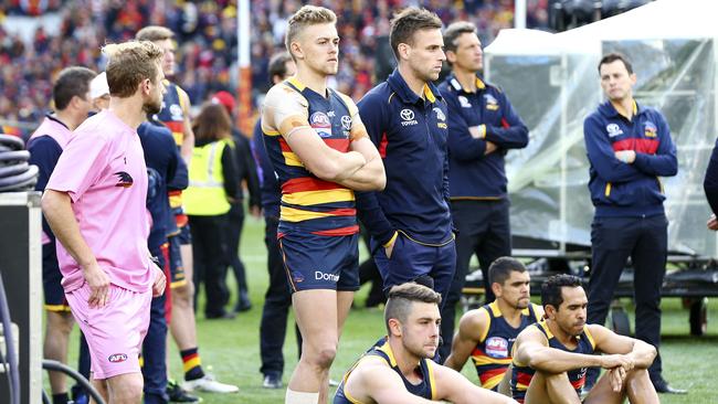 Brodie Smith, middle, with his Crows teammates watch the presentation after last year’s grand final. Picture Sarah Reed