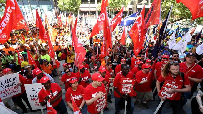 Demonstrators are seen during the 'Change the Rules' rally organised by the ACTU outside Parliament House in on Thursday. Picture: AAP Image/Kelly Barnes