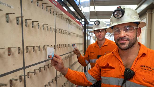 Underground operator Abdul Jenzarli (R) and Underground mine manager Brendan Murphy tag off from the Argyle diamond mine.